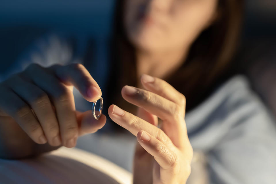 Close up of a woman removing her wedding ring