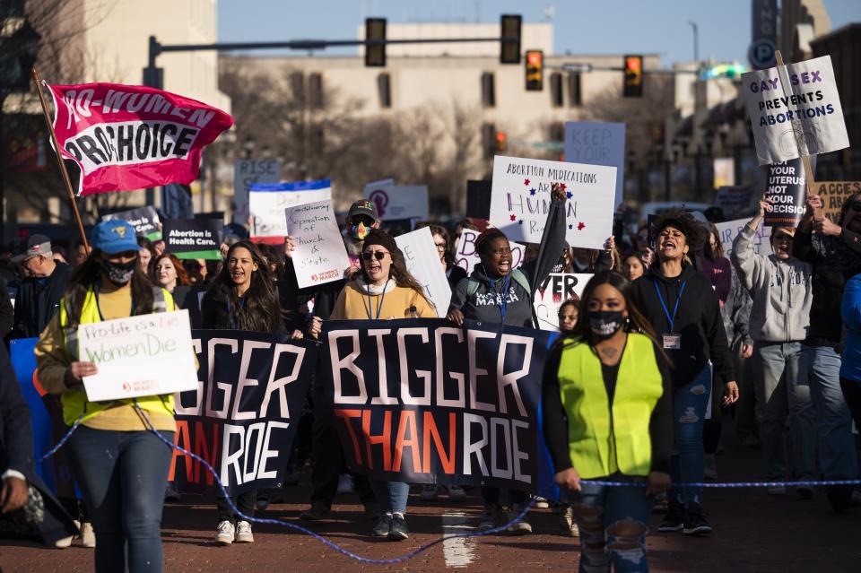 FILE - People march through downtown Amarillo to protest a lawsuit to ban the abortion drug mifepristone, Feb. 11, 2023, in Amarillo, Texas. A Colorado abortion fund said Thursday, May 9, 2024, it's helped hundreds access abortion in the first months of 2024, many arriving from Texas and other states where abortion is restricted, showing a continued increase in demand since the U.S. Supreme Court overturned Roe v. Wade in 2022. (AP Photo/Justin Rex, File)