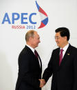 Chines President Hu Jintao, right, is greeted by his Russian counterpart Vladimir Putin during the arrival ceremony for the Asia-Pacific Economic Cooperation (APEC) Summit in Vladivostok, Russia, Saturday, Sept. 8, 2012. (AP Photo/Jim Watson, Pool)