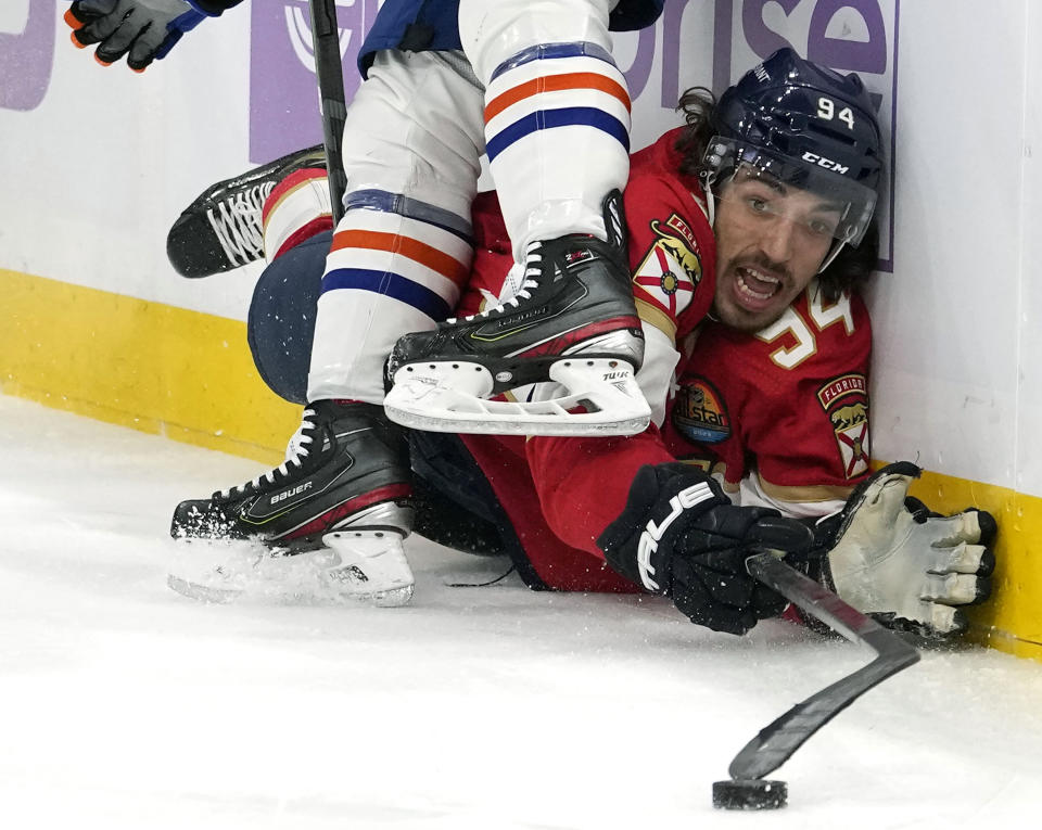 Florida Panthers left wing Ryan Lomberg (94) falls to the ice as he collides with Edmonton Oilers defenseman Tyson Barrie during the second period of an NHL hockey game, Saturday, Nov. 12, 2022, in Sunrise, Fla. (AP Photo/Lynne Sladky)