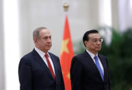 Israeli Prime Minister Benjamin Netanyahu (L) and China's Premier Li Keqiang attend a welcoming ceremony at the Great Hall of the People in Beijing, China March 20, 2017. REUTERS/Jason Lee