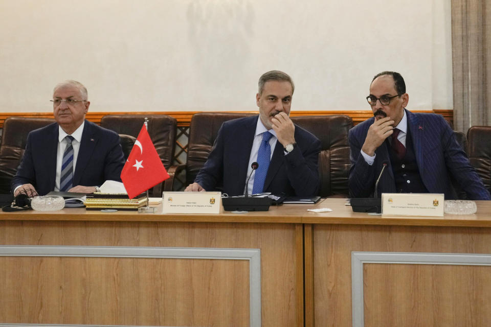 Turkish Foreign Minister Hakan Fidan, center, speaks during his meeting with Iraqi Foreign Minister Fouad Hussein, not pictured, at the Ministry of Foreign Affairs in Baghdad, Iraq, Thursday, March 14, 2024. (AP Photo/Hadi Mizban)