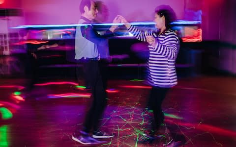 Kim Young-ran, right, the proprietor of Mia Cola-theque, dances with a partner at her discotheque in northern Seoul, South Korea - Credit: Jun Michael Park&nbsp;