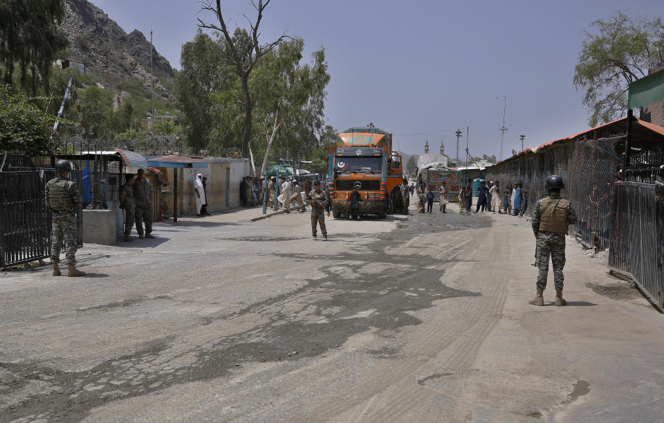 Pakistan and Afghan troops stand guard at Torkham border crossing, in Khyber district, Pakistan, Tuesday, Aug. 3, 2021. Pakistan's military said it completed 90 percent of the fencing along the border with Afghanistan, vowing the remaining one of the most difficult tasks of improving the border management will be completed this summer to prevent any cross-border militant attack from both sides. (AP Photo/Anjum Naveed)