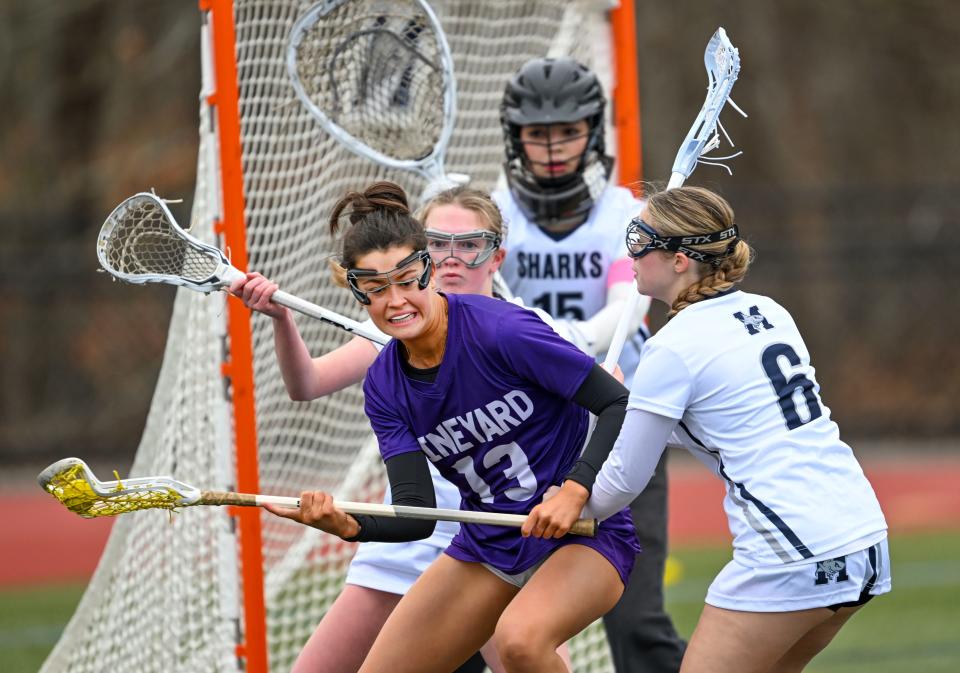 Ali Dyke of Martha's Vineyard turns on Emily Silverster (6) and Lucy Bates of Monomoy in front of their goalie Victoria Letendre.
