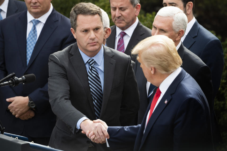 President and CEO of Walmart Inc. Doug McMillon (C) shakes hands with US President Donald Trump during press conference on COVID-19, known as the coronavirus, in the Rose Garden of the White House in Washington, DC, March 13, 2020. - Trump is declaring coronavirus a national emergency. (Photo by JIM WATSON / AFP) (Photo by JIM WATSON/AFP via Getty Images)