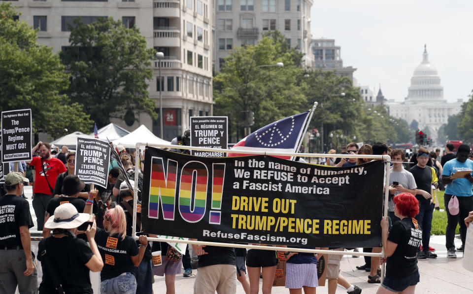 Groups protest in Freedom Plaza with the U.S. Capitol in the background, on the one year anniversary of Charlottesville's "Unite the Right" rally, Sunday, Aug. 12, 2018, in Washington. (AP Photo/Alex Brandon)