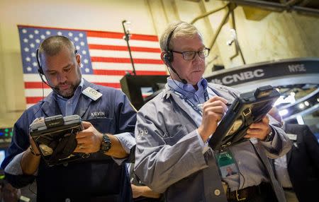 Traders work on the floor of the New York Stock Exchange August 15, 2014. REUTERS/Brendan McDermid