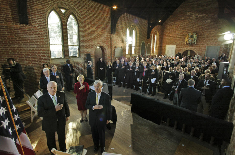 FILE - In this Jan. 10, 2007, file photo, Vice President Dick Cheney, left, is joined by Virginia House of Delegates speaker, William Howell, R-Stafford, front right, and others in the the Pledge of Allegiance during a commemorative session of the Virginia General Assembly in Historic Jamestown's Memorial Church in Jamestown, Va. Academics, lawmakers, dignitaries and maybe even the president will gather in Virginia this week for events celebrating the beginnings of American democracy four centuries ago. Tuesday, July 30, 2019, marks the 400th anniversary of the first meeting of the House of Burgesses. (AP Photo/Steve Helber, File)