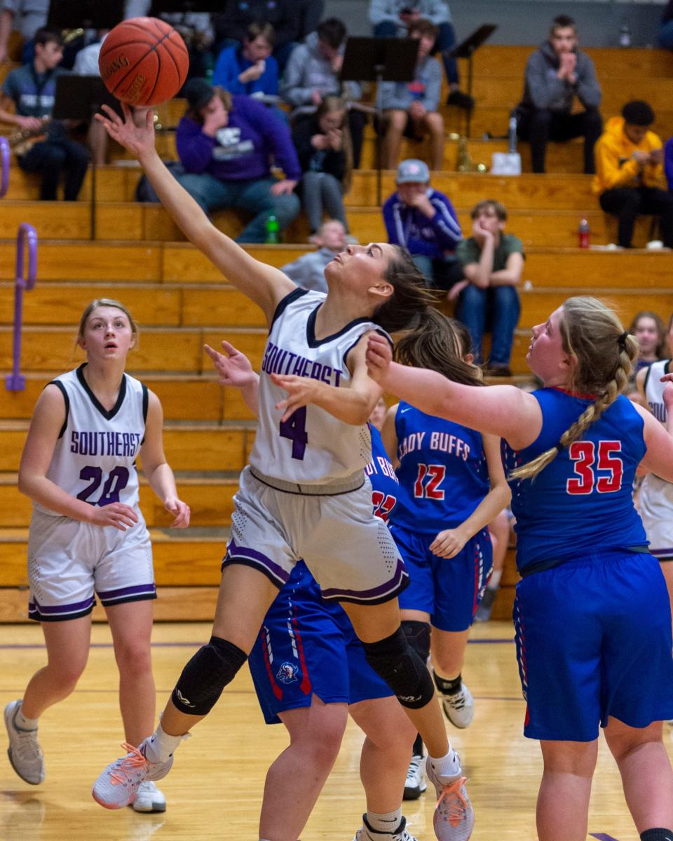 Karsyn Schlesener (4) of Southeast of Saline splits a pair of Republic County defenders in Tuesday's Trojan home victory, 63-12. 