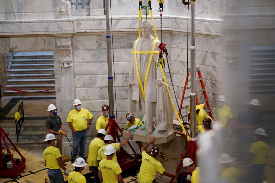 Kentucky Democratic Governor Andy Beshear operates a crane that removes a statue of Confederate President Jefferson Davis from the rotunda of the Capitol Building in Frankfort, Kentucky, U.S. June 13, 2020. (Bryan Woolston/Reuters)