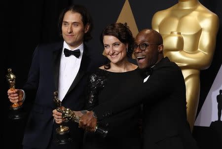 Jeremy Kleiner (izquierda), Adele Romanski y Barry Jenkins posan detrás del escenario con su premio Oscar a la mejor película por "Moonlight" en Hollywood, Estados Unidos, 26 febrero del 2017. "Moonlight", un drama sobre un joven negro que lucha con su sexualidad en un empobrecido barrio de Miami, recibió el Oscar a mejor película el domingo tras una equivocación sin precedentes en el que los presentadores anunciaron erróneamente que el musical "La La Land" había sido el ganador. REUTERS/Lucas Jackson