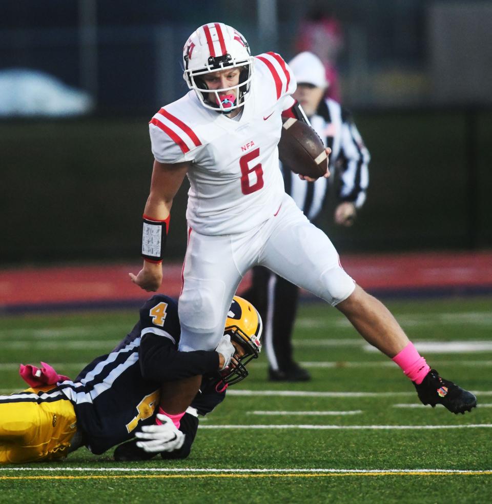 NFA's Gage Hinkley slips out of a tackle by Ledyard's Jaxon Barboza for a gain during the Wildcats' 19-14 win over Ledyard at Bill Mignault Field.