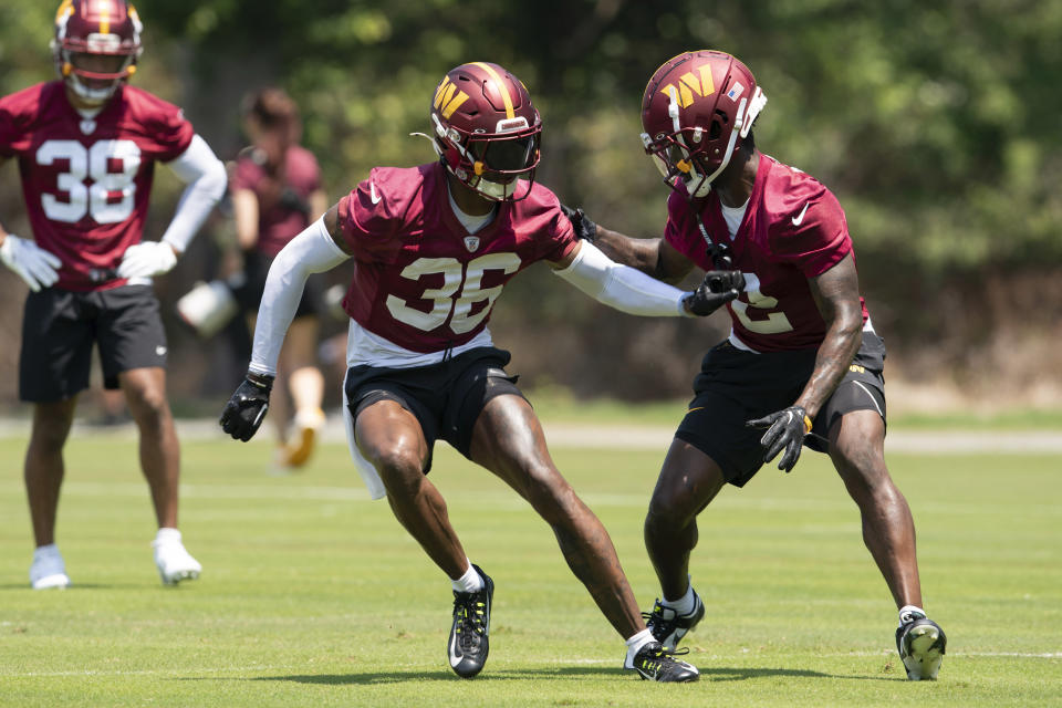 Washington Commanders Kyu Blu Kelly (36) and Mike Sainristil, right, run drills during NFL football practice in Ashburn, Va., Wednesday, May 22, 2024. (AP Photo/Jose Luis Magana)