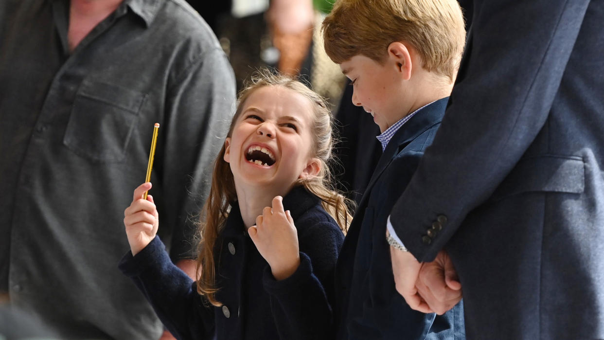  Princess Charlotte laughing with Prince George. 
