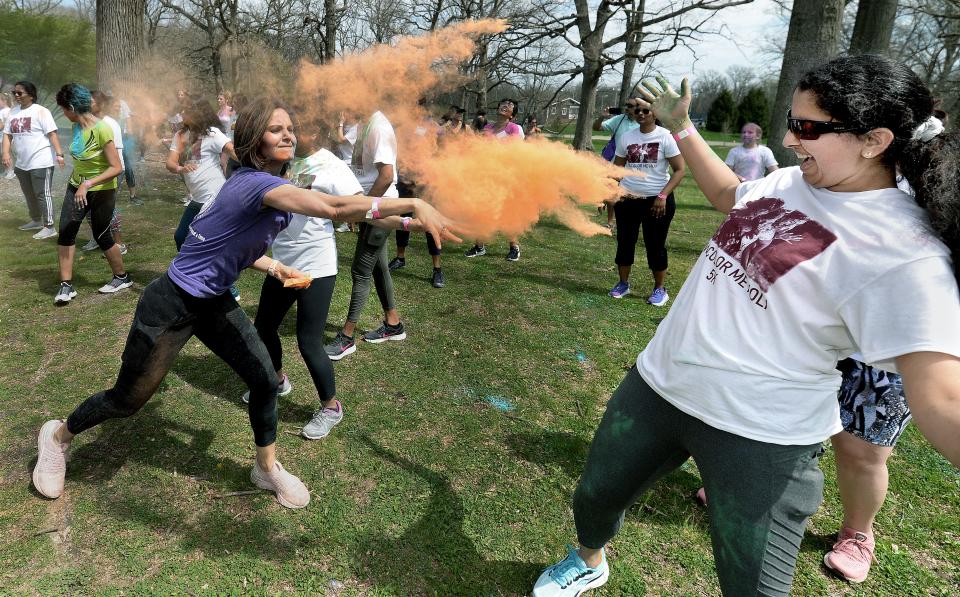Richa Pandey, left, throws colored powder onto Pavi Shetty in celebration of Holi, the Indian festival of colors at Washington Park on Saturday April 23, 2022. The second-ever Color Me Holi 5K Run/Walk is scheduled to take place April 27, 2024.