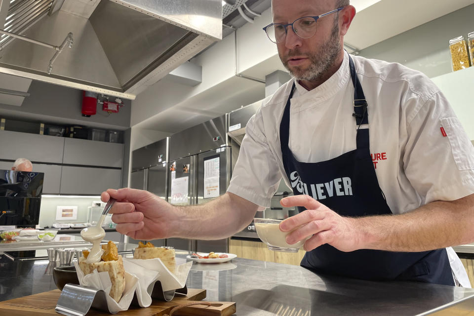 Believer Meats Research and Development Chef Andres Voloschin works on dishes made from the company's products at a test kitchen in Rehovot, Israel on Feb. 13, 2023. Believer is one of a growing number of companies making cultivated meat, which can be produced without raising and killing animals. (AP Photo/Laura Ungar)