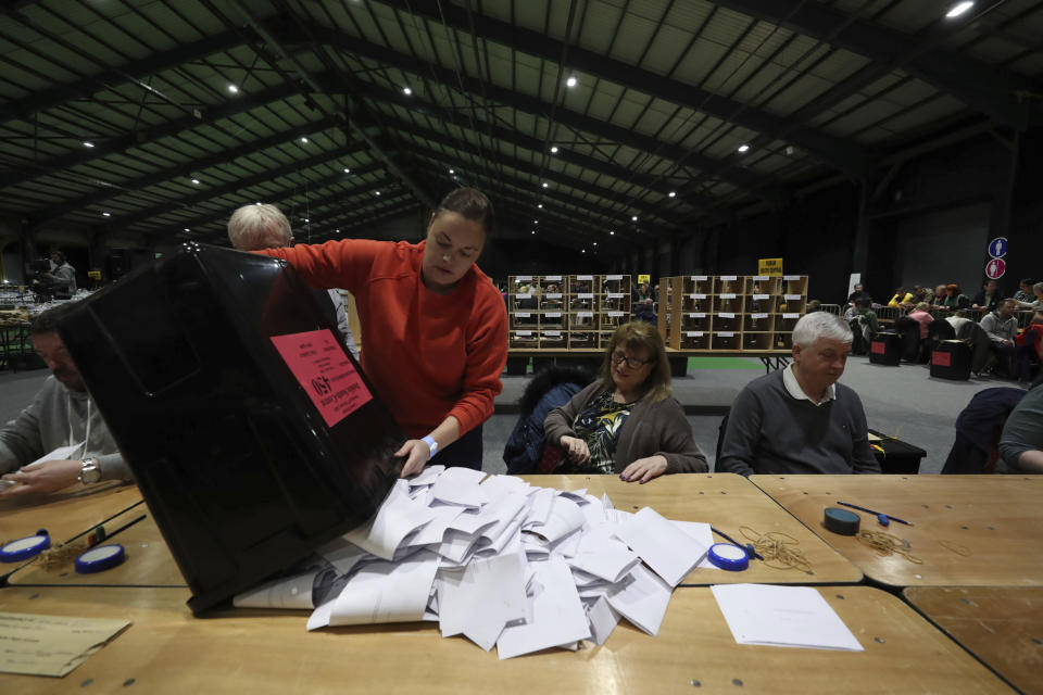 Ballot boxes are opened at the start of the Irish General Election count in Dublin, Sunday Feb. 9, 2020. Irish voters are choosing their next prime minister in an election where frustration with economic austerity and a housing crisis seem to have fuelled political uncertainty. (Niall Carson/PA via AP)