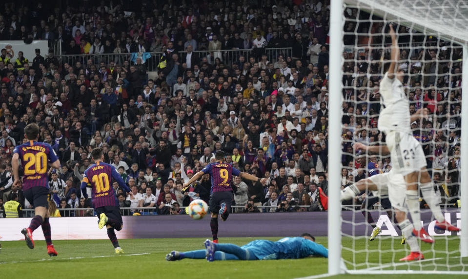 Barcelona forward Luis Suarez, center, celebrates after scoring his side's opening goal during the Copa del Rey semifinal second leg soccer match between Real Madrid and FC Barcelona at the Bernabeu stadium in Madrid, Spain, Wednesday Feb. 27, 2019. (AP Photo/Andrea Comas)
