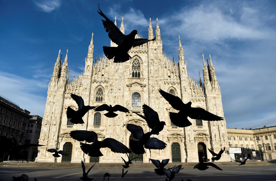 A pigeons fly in front of the Duomo Cathedral, amidst the coronavirus disease (COVID-19) spread, on Easter Sunday, in Milan, Italy, April 12, 2020. REUTERS/Flavio Lo Scalzo