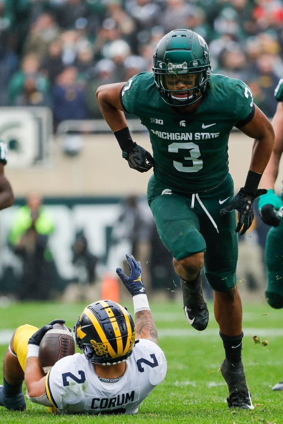 Michigan State safety Xavier Henderson celebrates a tackle against Michigan running back Blake Corum during the second half at Spartan Stadium in East Lansing on Saturday, Oct. 30, 2021.