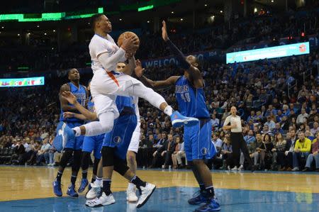 Jan 26, 2017; Oklahoma City, OK, USA; Oklahoma City Thunder guard Russell Westbrook (0) drives to the basket in front of Dallas Mavericks forward Harrison Barnes (40) during the fourth quarter at Chesapeake Energy Arena. Mandatory Credit: Mark D. Smith-USA TODAY Sports