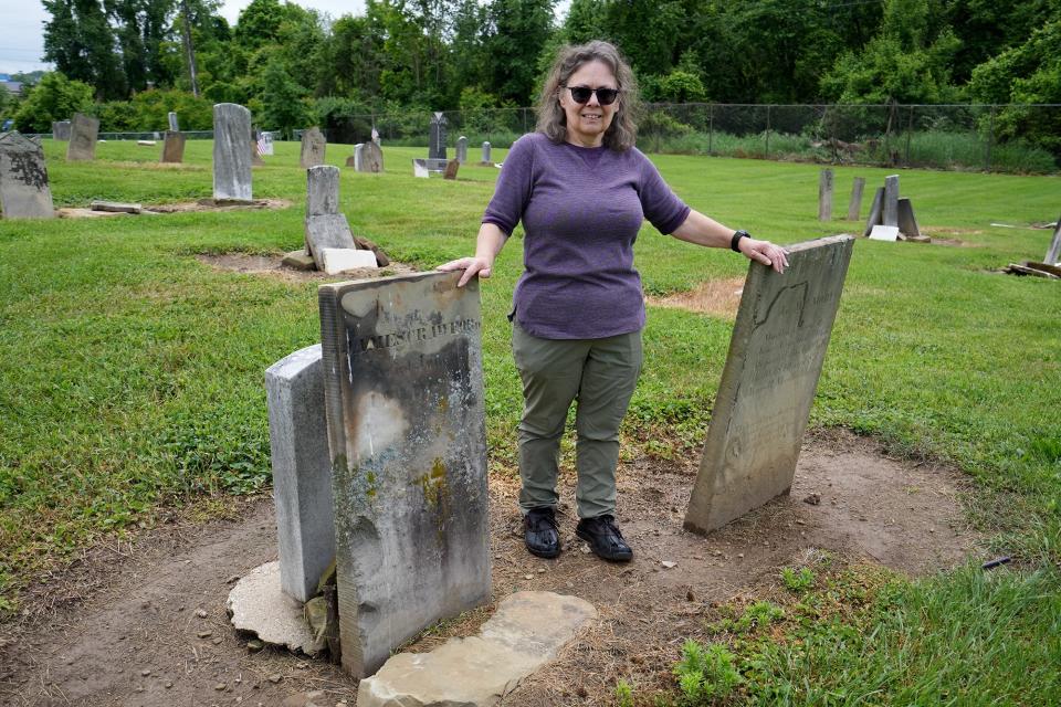 Diana Morse,  one-time naturalist at nearby Blacklick Woods Metro Park, poses with the tombstones of James and Martha Crawford at Seceder Cemetery. The Crawfords were married on July 4, 1776, were refugees from Nova Scotia and sided with the colonists in the Revolutionary War.