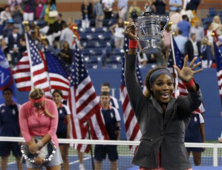 Serena Williams of the U.S. raises her trophy after defeating Azarenka of Belarus in their women's singles final match at the U.S. Open tennis championships in New York