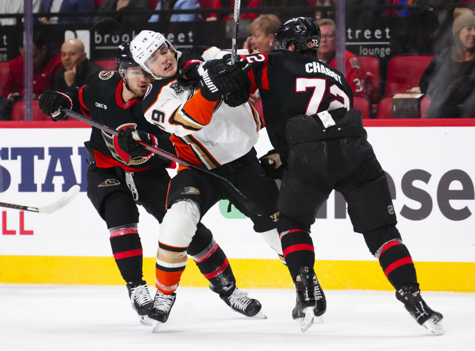 Ottawa Senators defenseman Thomas Chabot (72) hits Anaheim Ducks right wing Troy Terry (19) during first-period NHL hockey game action in Ottawa, Ontario, Thursday, Feb. 15, 2024. (Sean Kilpatrick/The Canadian Press via AP)