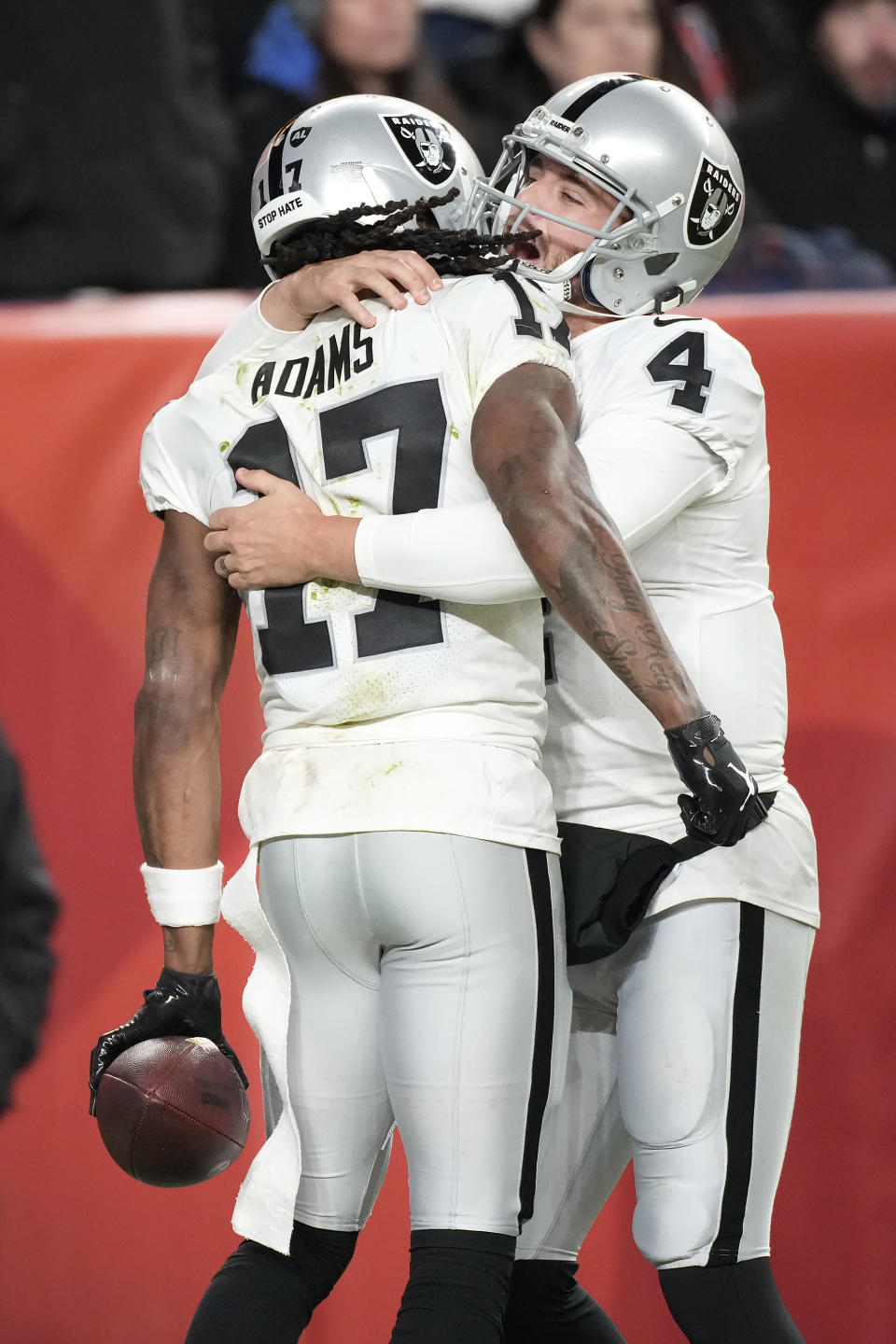 Las Vegas Raiders wide receiver Davante Adams, left, celebrates with quarterback Derek Carr after Adams scored the winning touchdown during overtime of an NFL football game against the Denver Broncos in Denver, Sunday, Nov. 20, 2022. (AP Photo/David Zalubowski)