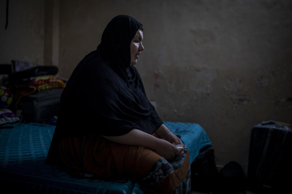 Refugee and former Afghan policewoman Khatera Hashmi sits inside a rented accommodation in New Delhi, India on Aug. 13, 2021. When the Taliban shot policewoman Khatira Hashmi and gouged out her eyes, she knew Afghanistan was no longer safe. Along with her husband, she fled to India last year. She was shot multiple times on her way home from work last October in the capital of Ghazni province, south of Kabul. As she slumped over, one of the attackers grabbed her by the hair, pulled a knife and gouged out her eyes. (AP Photo/Altaf Qadri)