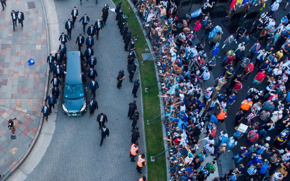 The hearse carrying the casket of Diego Maradona leaves the government house in Buenos Aires - AP Photo/Mario De Fina