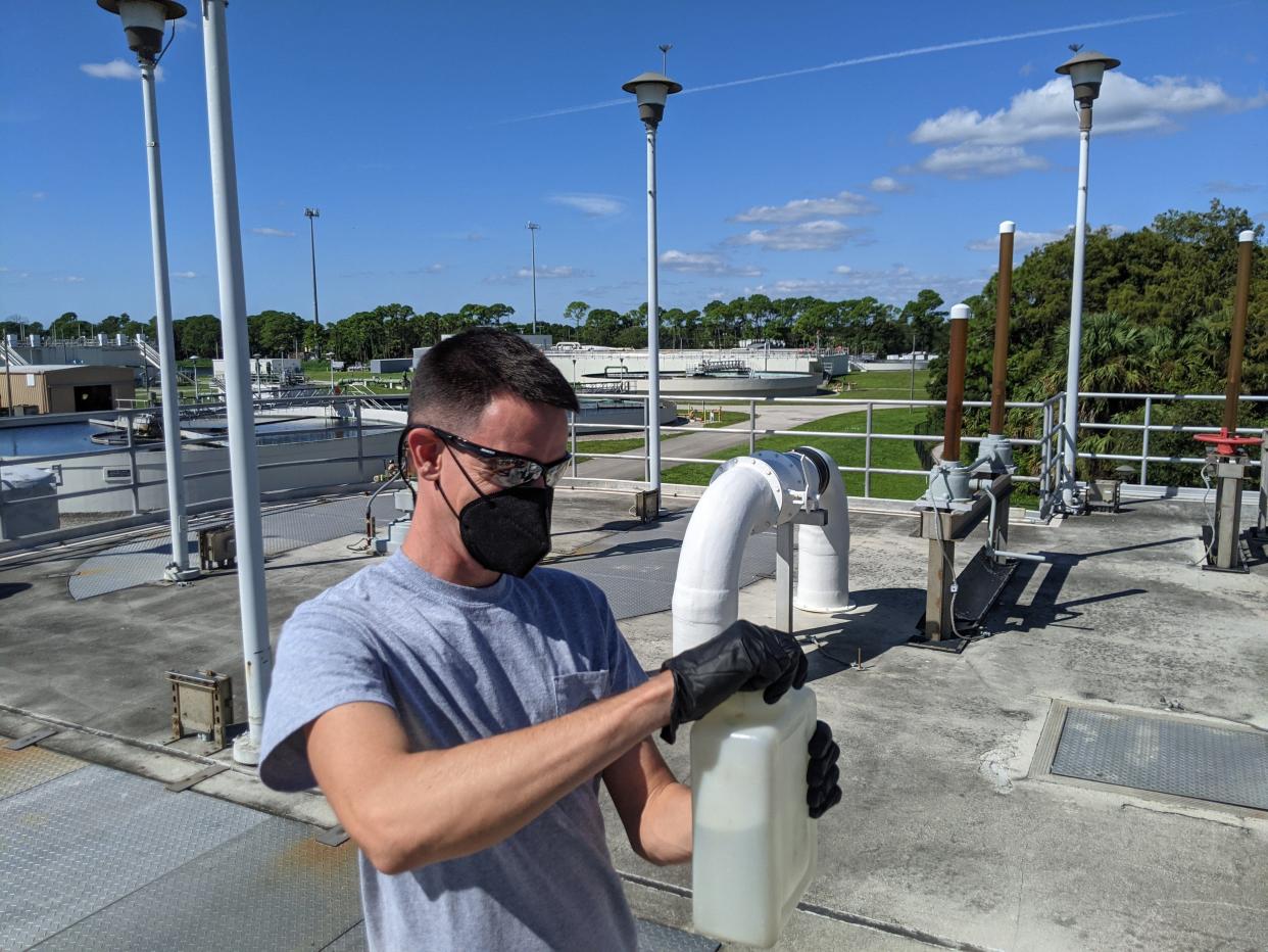 Danny Tomasello, a laboratory technician at the Loxahatchee River District, collects a wastewater sample.