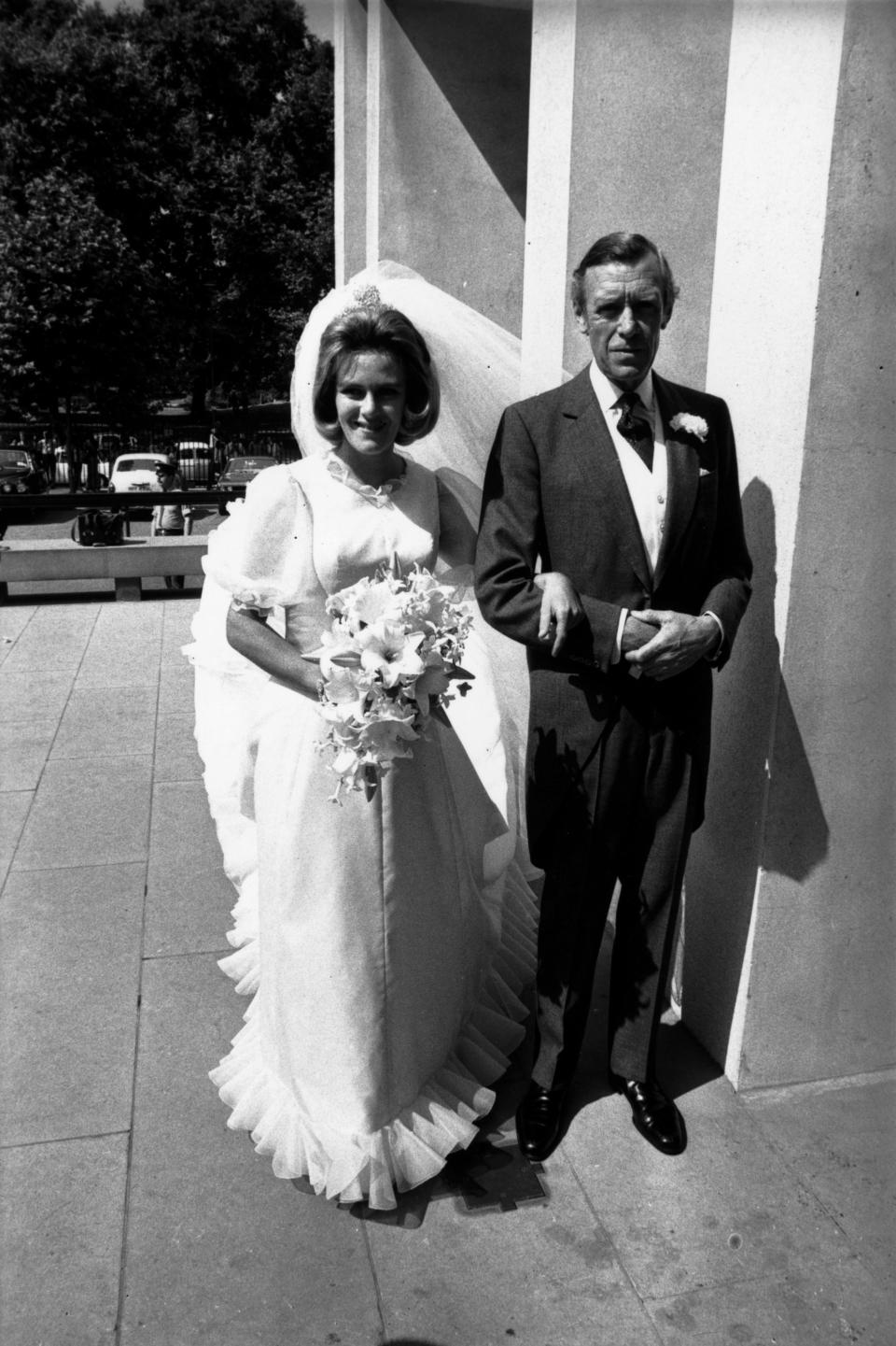 4th July 1973:  Camilla Shand arrives at the Guard's Chapel for her wedding to Andrew Parker-Bowles, on the arm of her father Major Bruce Shand.  (Photo by Frank Barratt/Keystone/Getty Images)