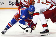 New York Rangers center Vincent Trocheck (16) and Carolina Hurricanes center Jordan Staal fight for the puck during the first period in Game 1 of an NHL hockey Stanley Cup second-round playoff series, Sunday, May 5, 2024, in New York. (AP Photo/Julia Nikhinson)
