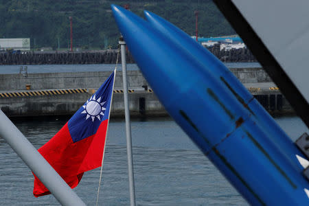 A Taiwanese flag is seen behind standard Type II missiles on Kee Lung (DDG-1801) destroyer during a drill near Yilan naval base, Taiwan April 13, 2018. REUTERS/Tyrone Siu