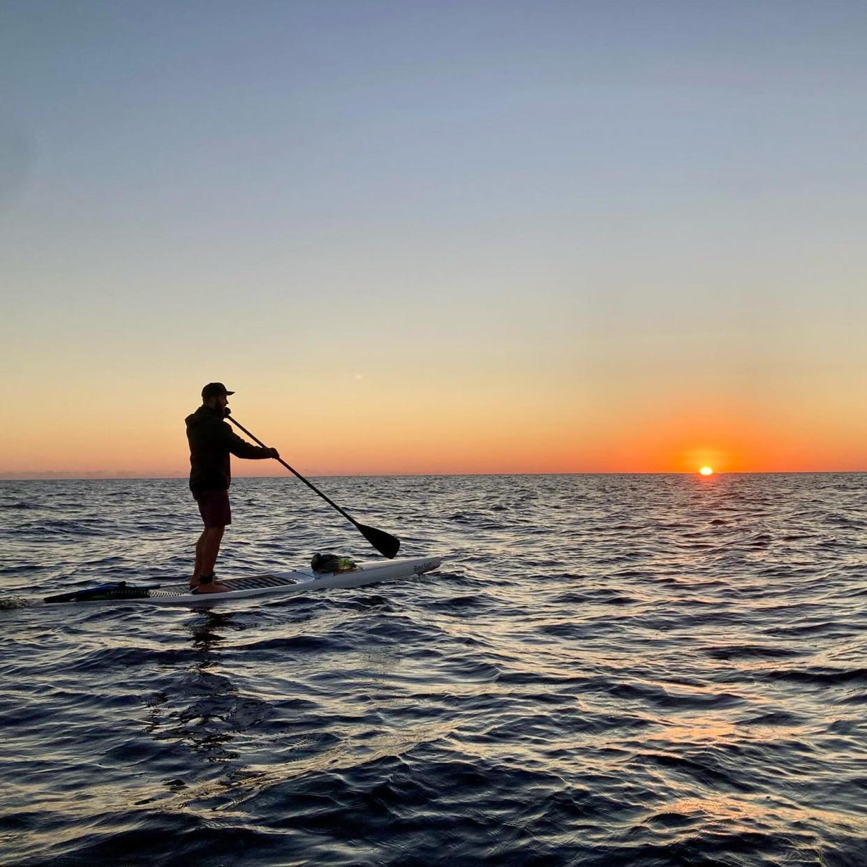 Jordon Wolfram of Lakeland paddles on Lake Okeechobee at sunrise on Dec. 31. He and a friend, Mason Gravley, believe they are the first to paddle the length of Florida's largest lake.