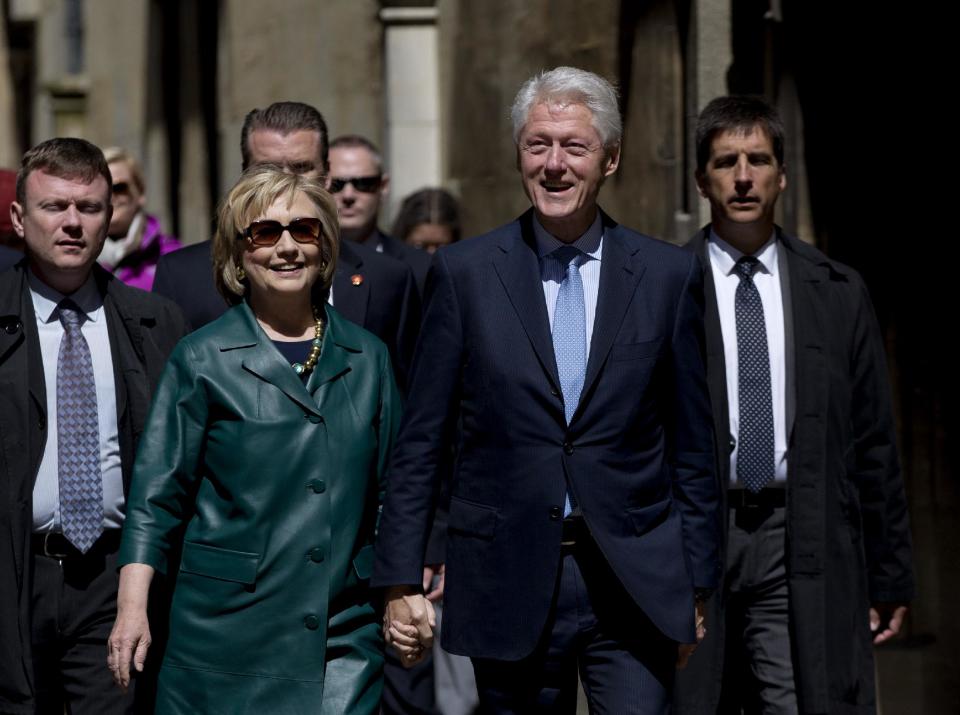Former U.S. President Bill Clinton, center right, and his wife former Secretary of State Hillary Rodham Clinton, center left, walk away after they attended their daughter Chelsea's Oxford University graduation ceremony held at the Sheldonian Theatre in Oxford, England, Saturday, May 10, 2014. Chelsea Clinton received her doctorate degree in international relations on Saturday from the prestigious British university. Her father was a Rhodes scholar at Oxford from 1968 to 1970. The graduation ceremony comes as her mother is considering a potential 2016 presidential campaign. (AP Photo/Matt Dunham)