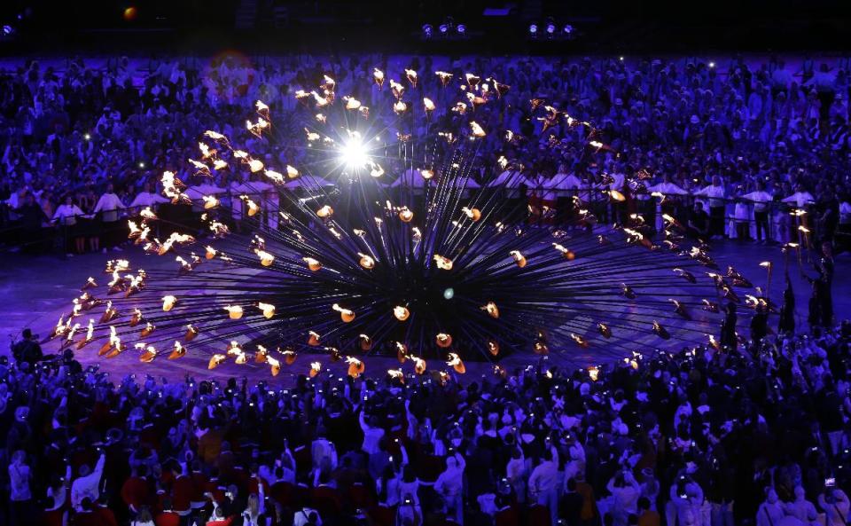 FILE - The Olympic cauldron is lit during the Opening Ceremony at the 2012 Summer Olympics, in this Saturday, July 28, 2012 file photo, in London. Britain's tallest building, the 2012 Olympic cauldron and a non-stick ketchup bottle are among contenders for a major design award. London's Design Museum on Monday Jan 14 2013 announced nominees for its Designs of the Year prizes in seven categories including architecture, fashion, transport and digital media. (AP Photo/Mark Baker, File)