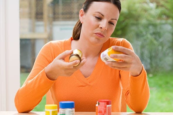 Woman choosing between supplements