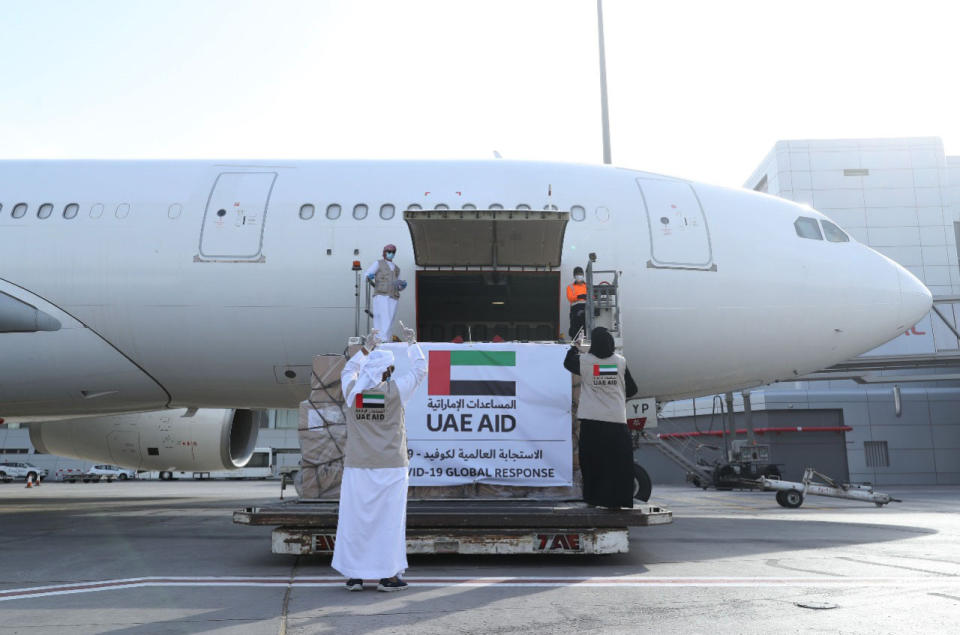 In this Tuesday, May 19, 2020 photo released by the state-run WAM news agency, an Etihad Airways flights loaded with aid for the Palestinians to fight the coronavirus pandemic is loaded in Abu Dhabi, United Arab Emirates. Etihad Airways flew aid for the Palestinians amid the coronavirus pandemic from the capital of the United Arab Emirates into Israel on Tuesday, marking the first known direct commercial flight between the two nations. (WAM via AP)