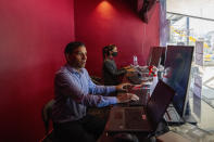 Employees of the newly constructed 'INOX' multiplex work inside the ticket counter ahead of the inauguration in Srinagar, Indian controlled Kashmir, Monday, Sept. 19, 2022. The multi-screen cinema hall has opened in the main city of Indian-controlled Kashmir for public for the first time in 14 years. The 520-seat hall with three screens opened on Saturday, Oct. 1, amid elaborate security but only about a dozen viewers lined up for the first morning show. (AP Photo/Dar Yasin)