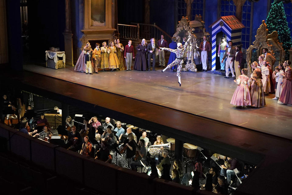 Ballet Arizona musicians, bottom, and dancers rehearse for the "Nutcracker", Thursday, Dec. 7, 2023, in Phoenix prior to an upcoming performance. A pit full of musicians is part of the tradition of the holiday staple for Ballet Arizona and many other productions around the world. Shows use recordings as they weather costs or crises like recessions. But fans, musicians and the unions that represent them say the live music brings an unseen signature to each show. (AP Photo/Matt York)