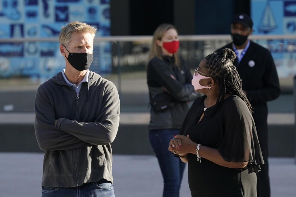 Golden State Warriors head coach Steve Kerr, left, talks with Donzaleigh Artis, mother of draft pick James Wiseman, in San Francisco, Thursday, Nov. 19, 2020. (AP Photo/Jeff Chiu)