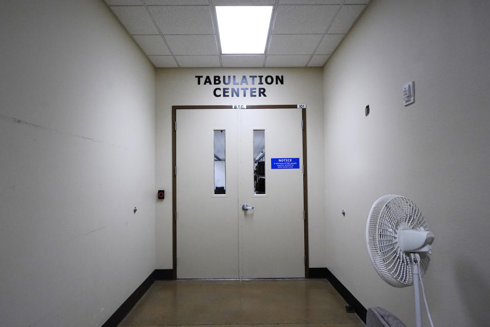 The doors to the Tabulation Center are locked to all but essential election personnel at the Maricopa County Elections Department in Phoenix, Thursday, Sept. 8, 2022. Maricopa County election officials, like many others around the country, have begun pushing back against a flood of misinformation related to voting that often leads to public confusion and anger. (AP Photo/Ross D. Franklin)