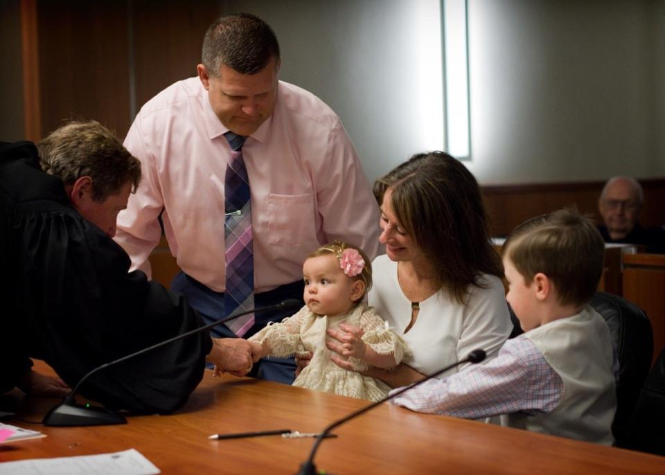 "I met this family the day of their adoption. They adopted their son and were now adding a little girl. The grandparents were also present at the adoption. The judge was so sweet. He took his time and made sure to get to know the family." -- Aimee Butier