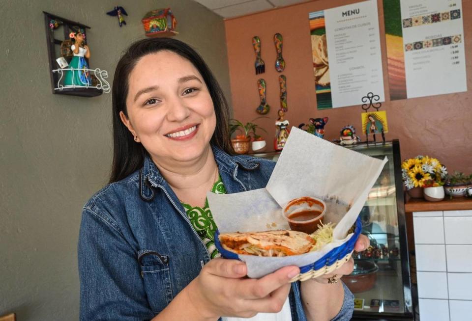 Lizett Perez holds up one of her gorditas in her new Fresno restaurant, Lucy’s Gorditas, on Wednesday, April 19, 2023.