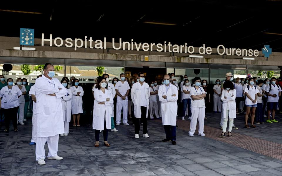 Health workers in Spain during a minute of silence in memory of those who died of Covid-19 - Brais Lorenzo/EPA-EFE/Shutterstock