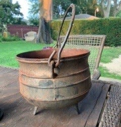 The molded words on this cast-iron three-leg pot indicate production to be after World War I.