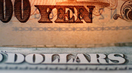 FILE PHOTO - The word "Yen" is pictured on a Japanese banknote on top of a U.S. dollar bill at Interbank Inc. Money exchange in Tokyo, Japan in this September 9, 2010 picture illustration. REUTERS/Yuriko Nakao/File Photo